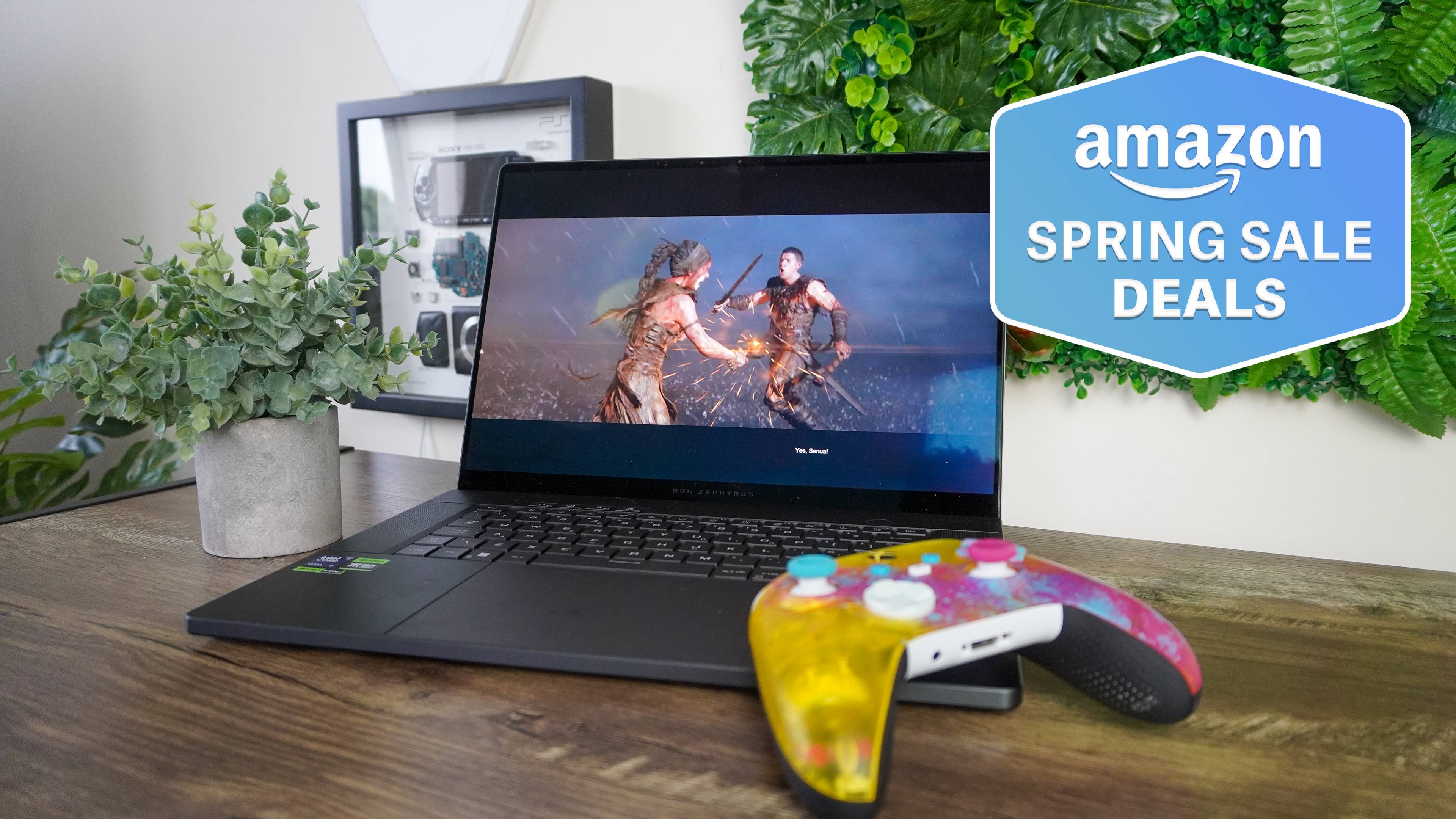 Asus Rog Zephyrus G16 sur la table avec contrôleur de jeu reposant dessus avec Amazon Spring Sale Offres Badge