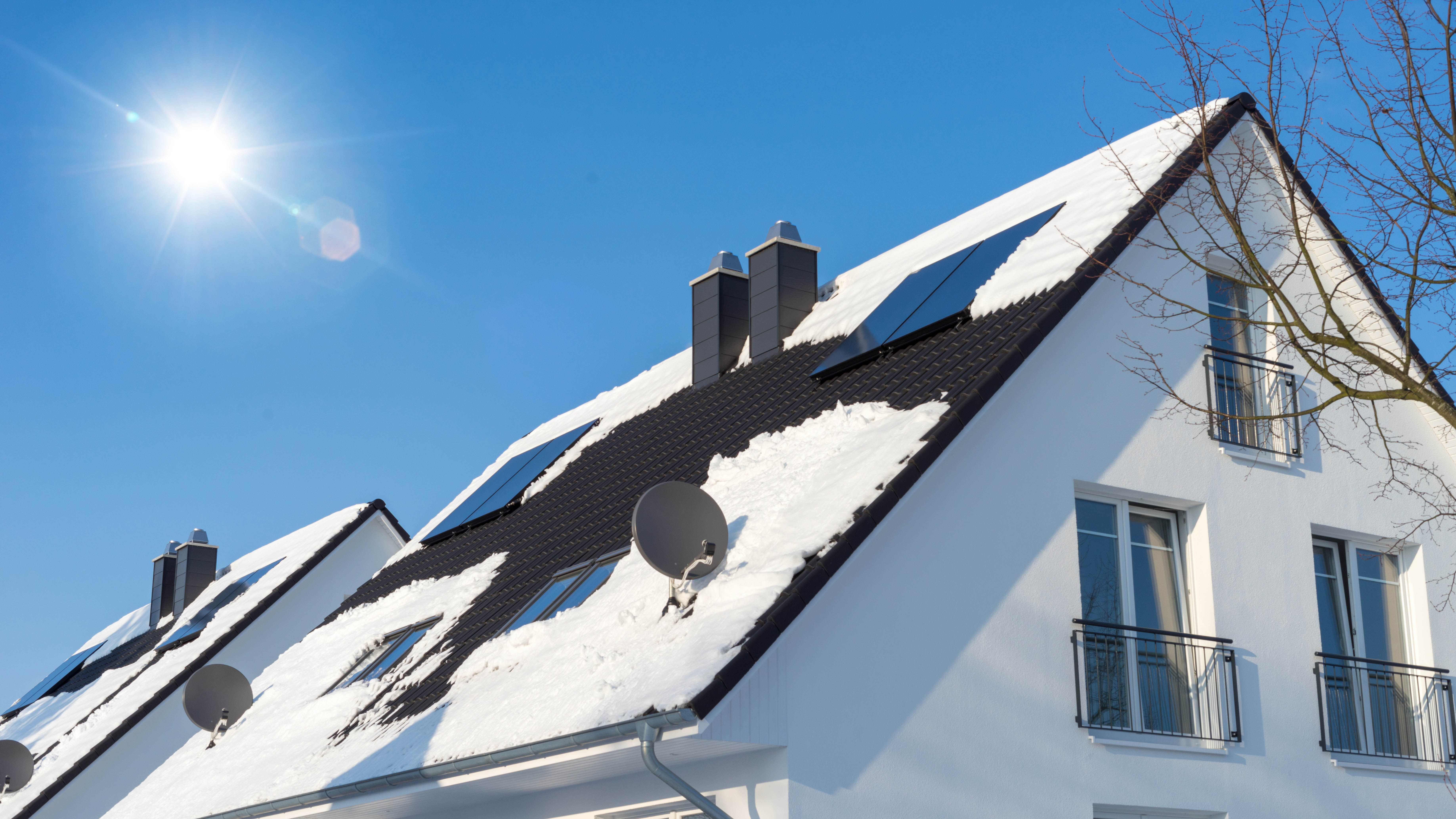 Toit avec panneaux solaires recouvert de neige