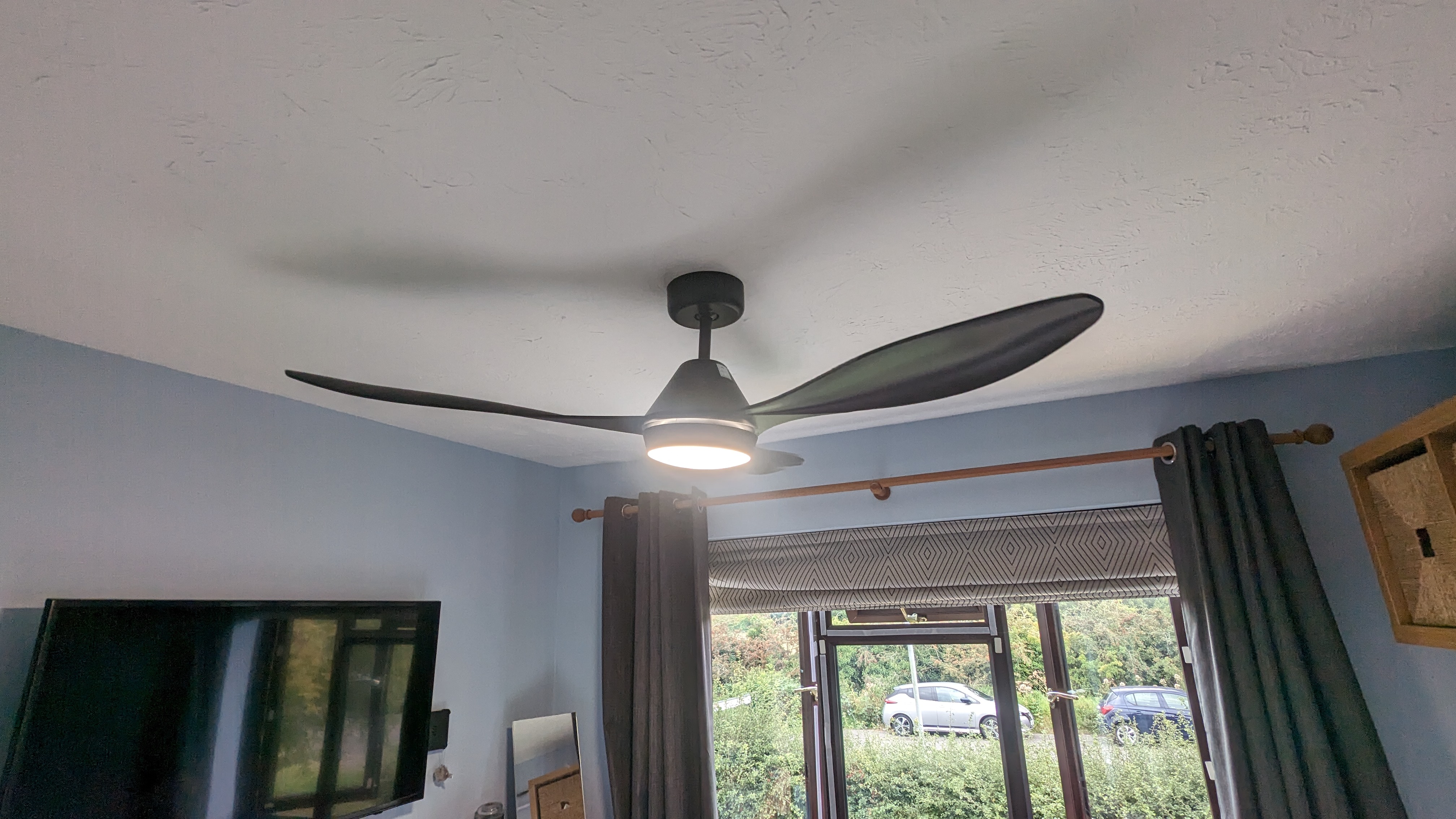 ventilateur de plafond noir ion pièce aux murs bleus