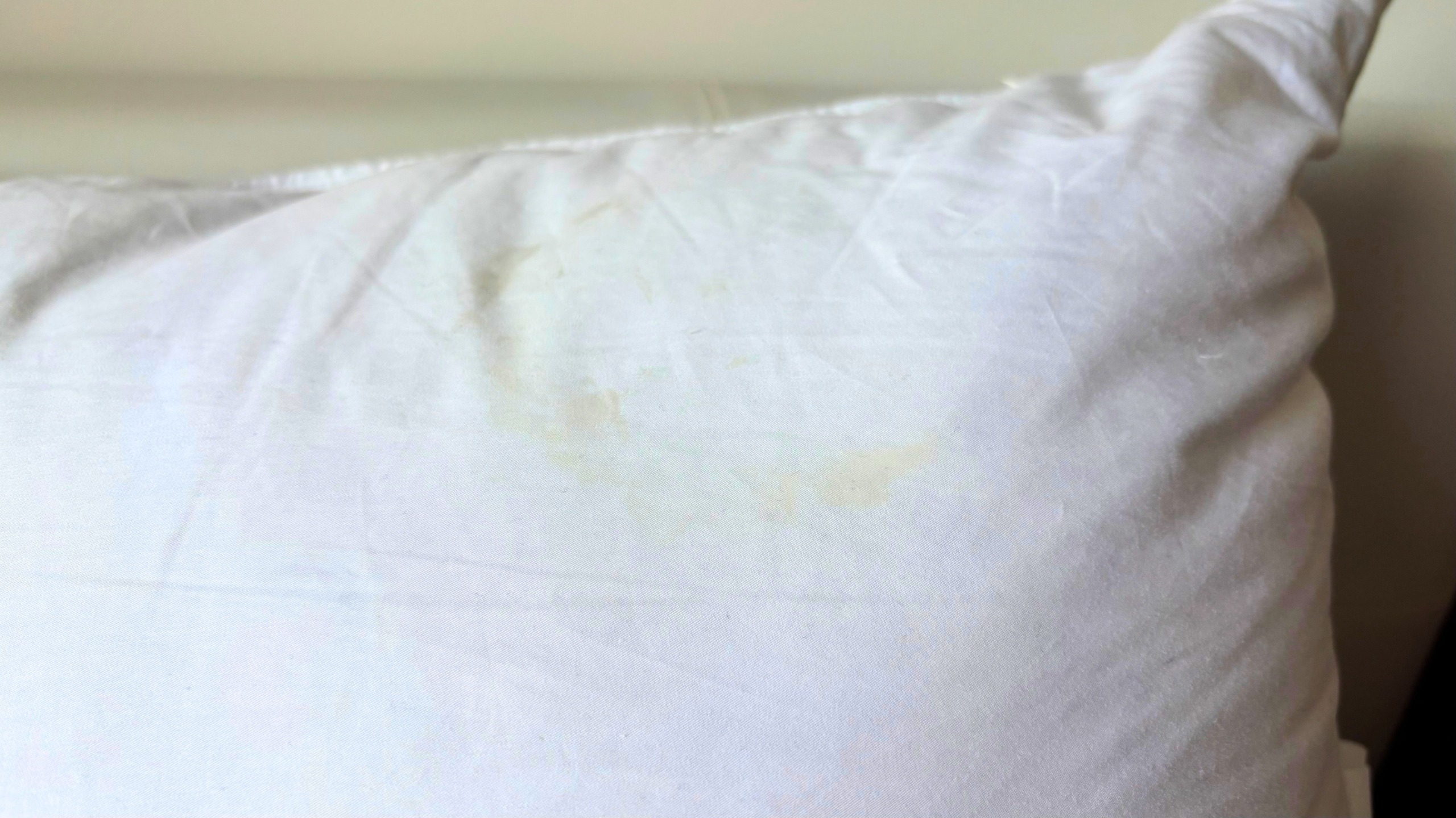 Un oreiller avec une tache jaune de rétinol.